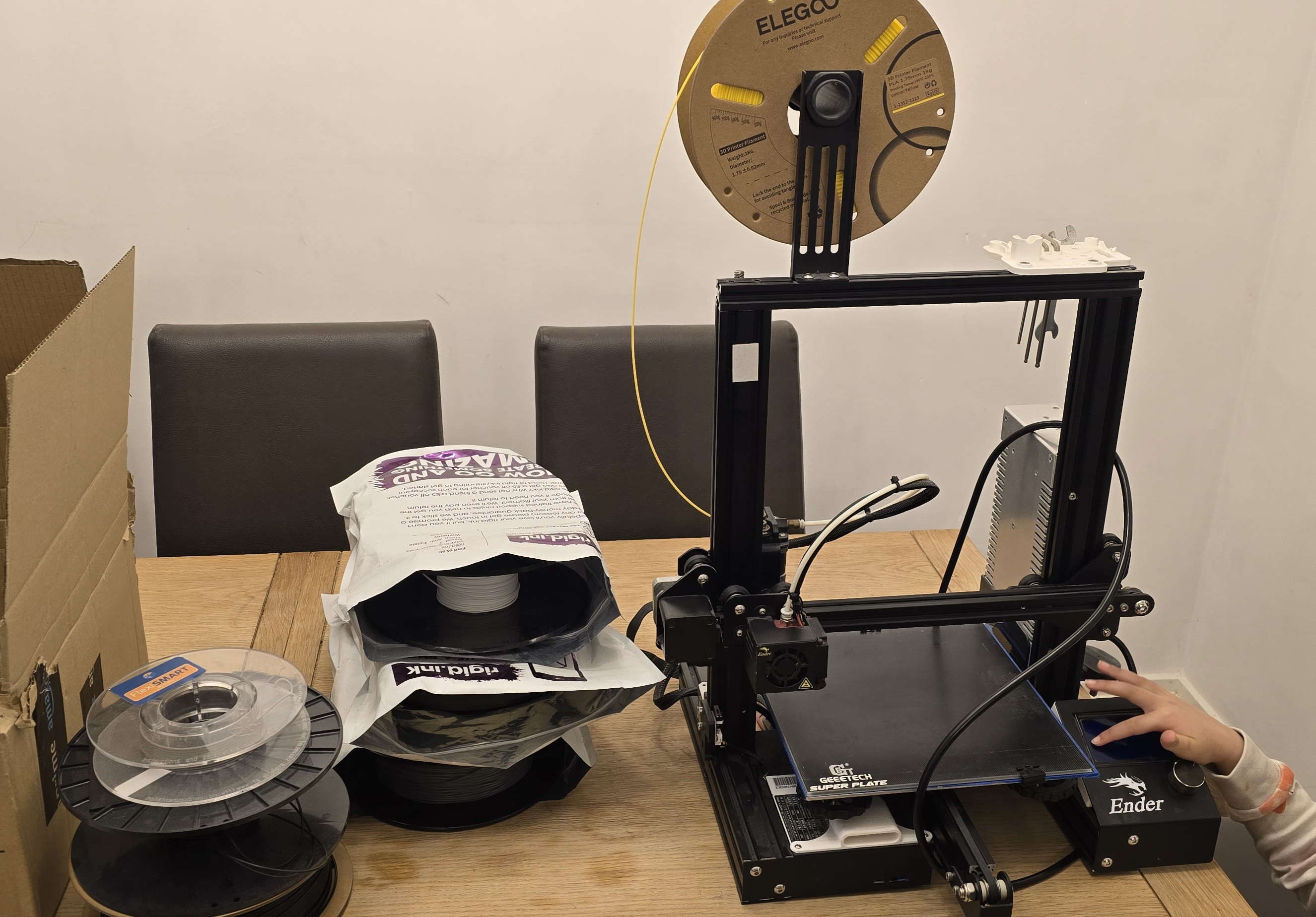 My new (to me) Ender 3, ready for its first print—with my daughter’s curious fingers sneaking into the frame